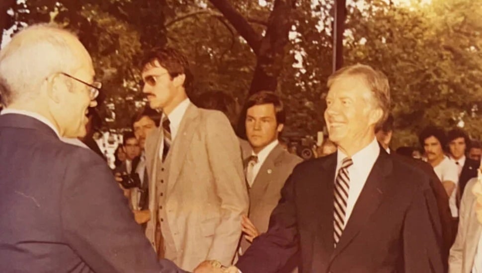 Joseph Phillips greets former President Jimmy Carter outside his Lansdowne home.