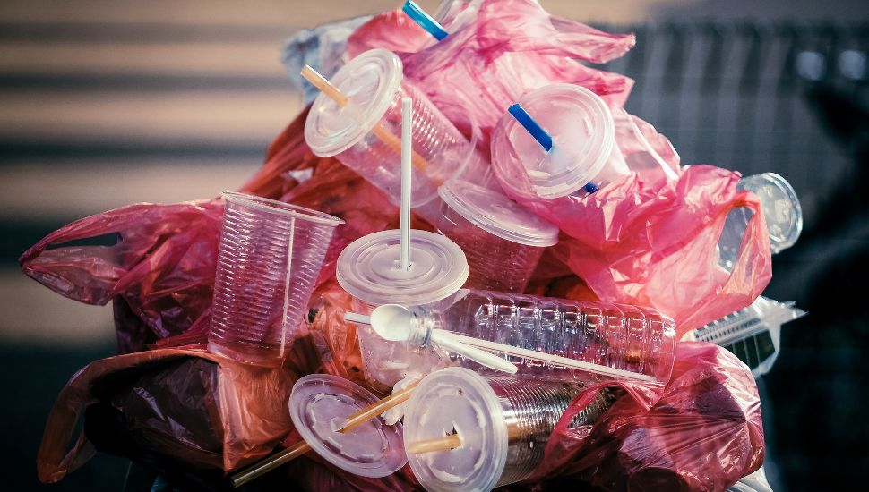 Pile of plastic bags, cups, and straws.