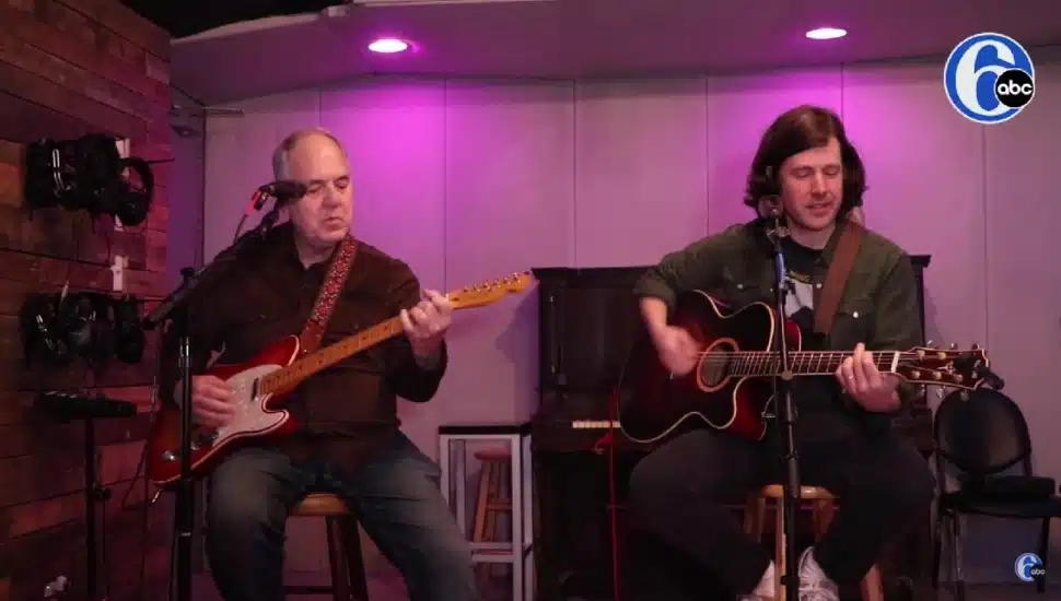 Bill (left) and Todd (right) Mecaughey playing the guitar together.