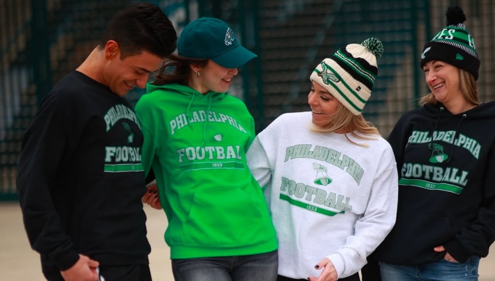 Four people wearing Eagles gear from Blessed in Distress.