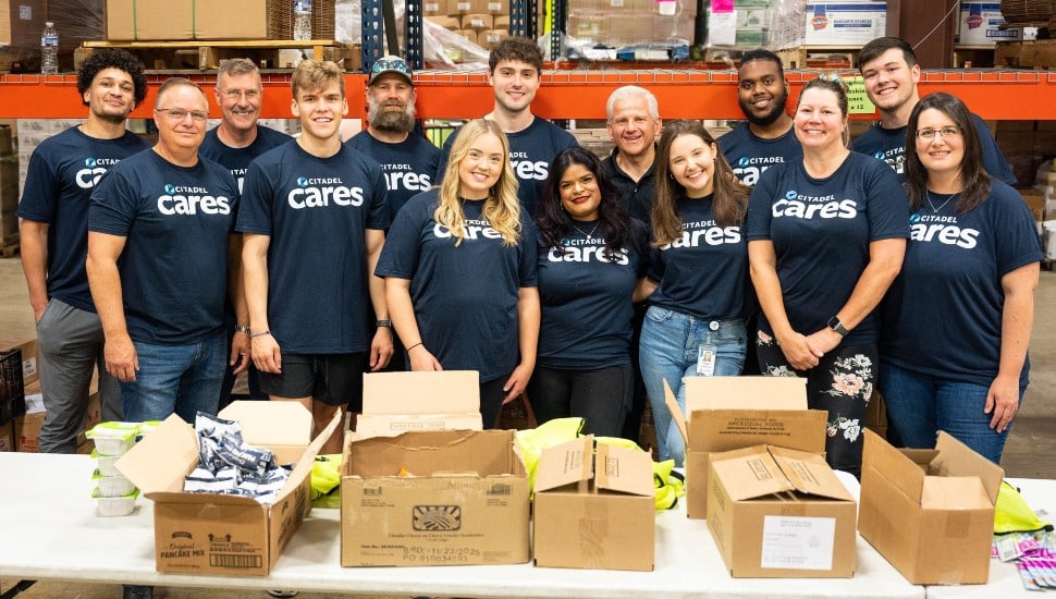 Group photo of bank employees volunteering.