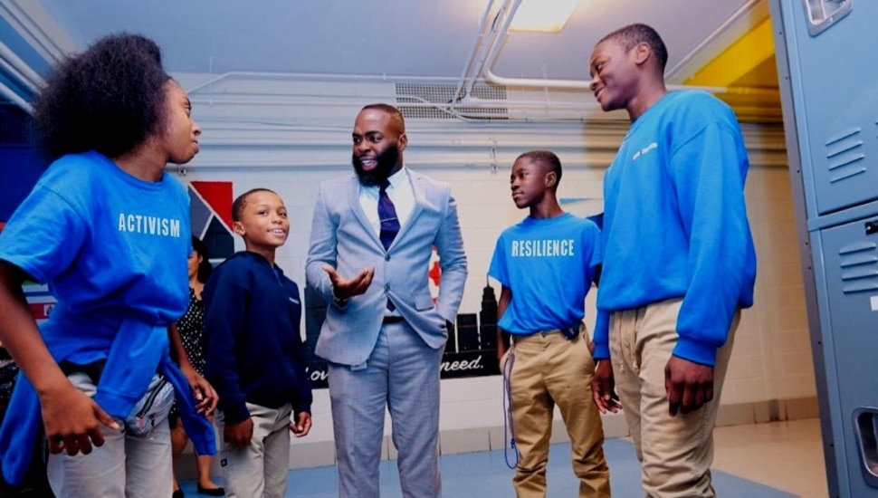 An instructor with students surrounding him.