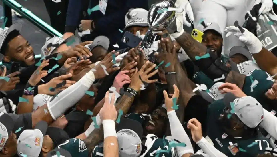 Eagles players holding up the Lombardi Trophy after winning the Super Bowl.