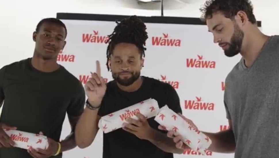 DeVonta Smith, Avante Maddox, and Dallas Goedert holding Wawa hoagies.