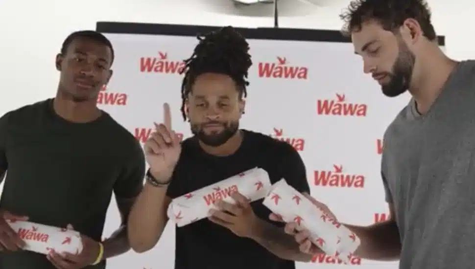 DeVonta Smith, Avante Maddox, and Dallas Goedert holding Wawa hoagies.