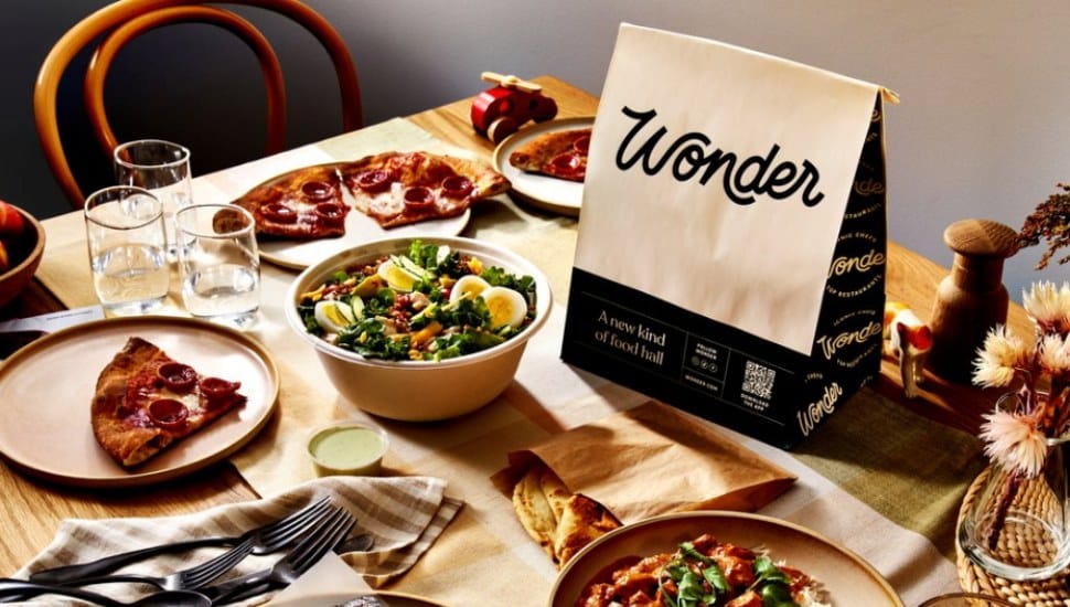 Wonder food hall table with plates of food on it.