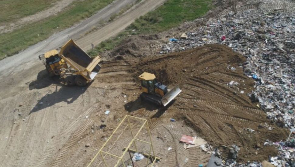 Dumptrucks move landfill waste.