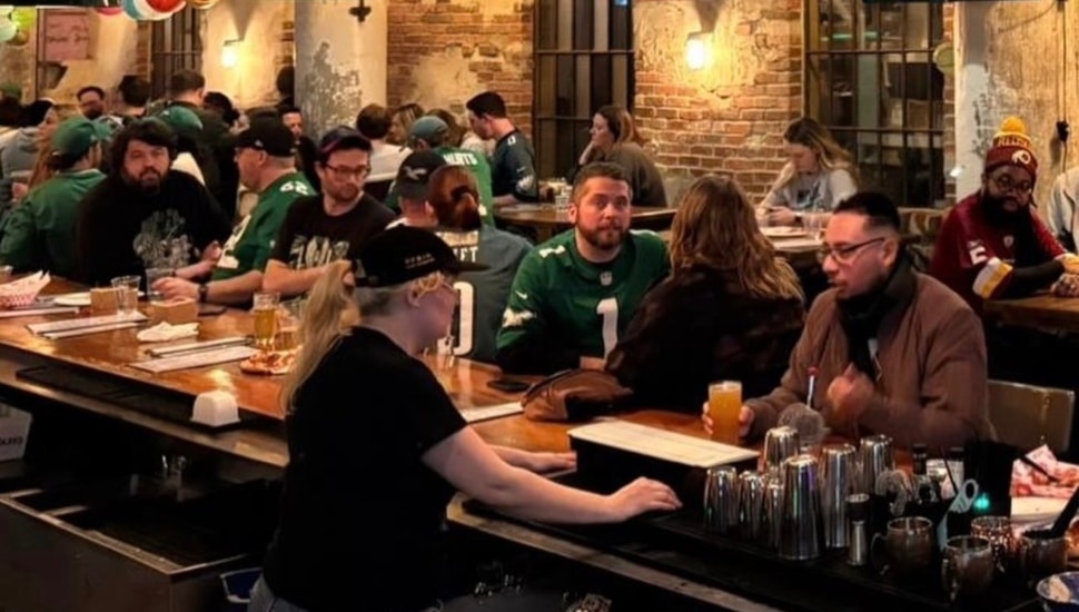 People enjoying drinks at Love City Brewing.