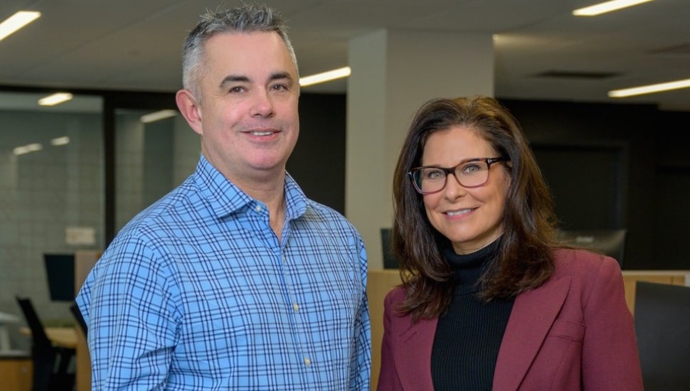 Male and female banking executives pose for a picture.