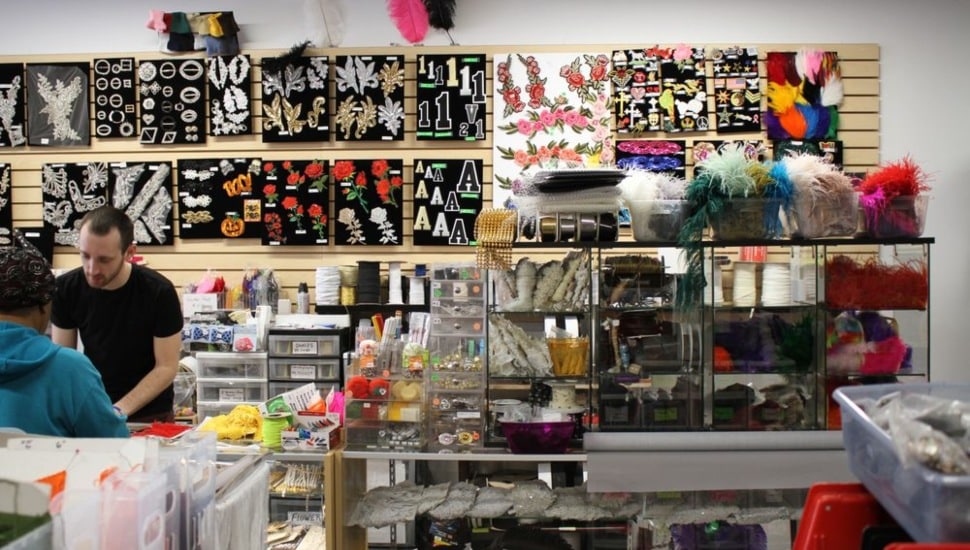 An employee and customer inside Fleishman Fabrics & Supplies.