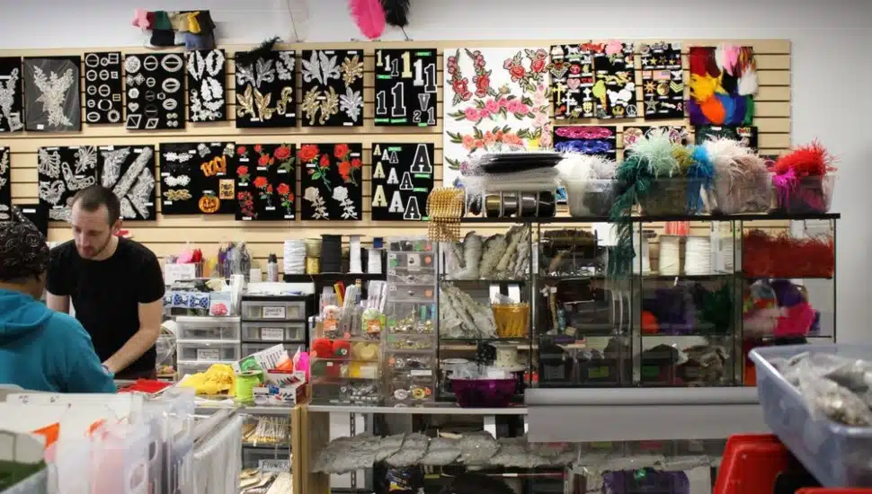 An employee and customer inside Fleishman Fabrics & Supplies.