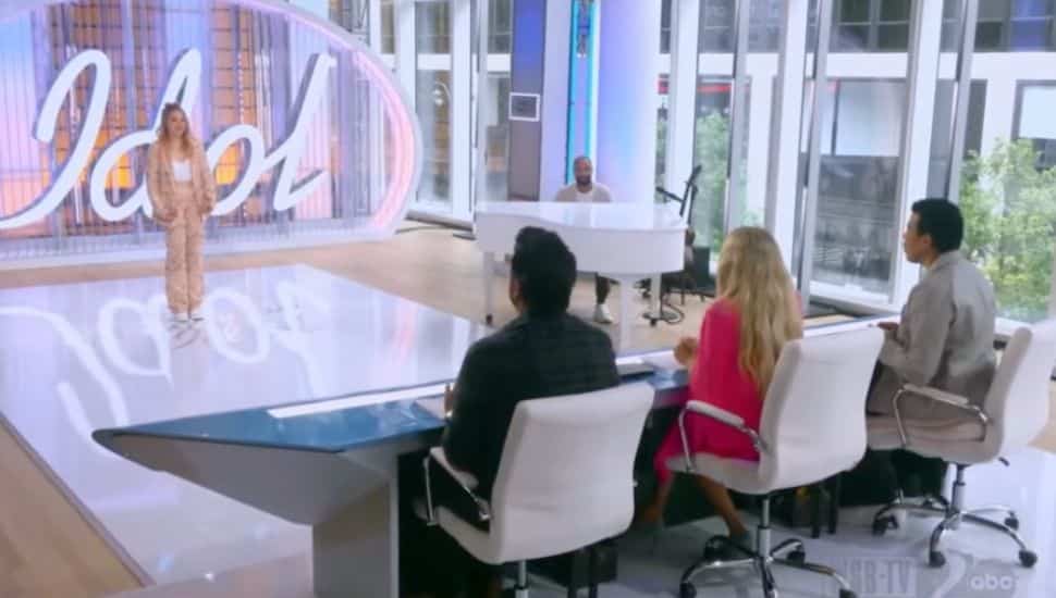 Penny Samar singing in front of 3 American Idol judges.