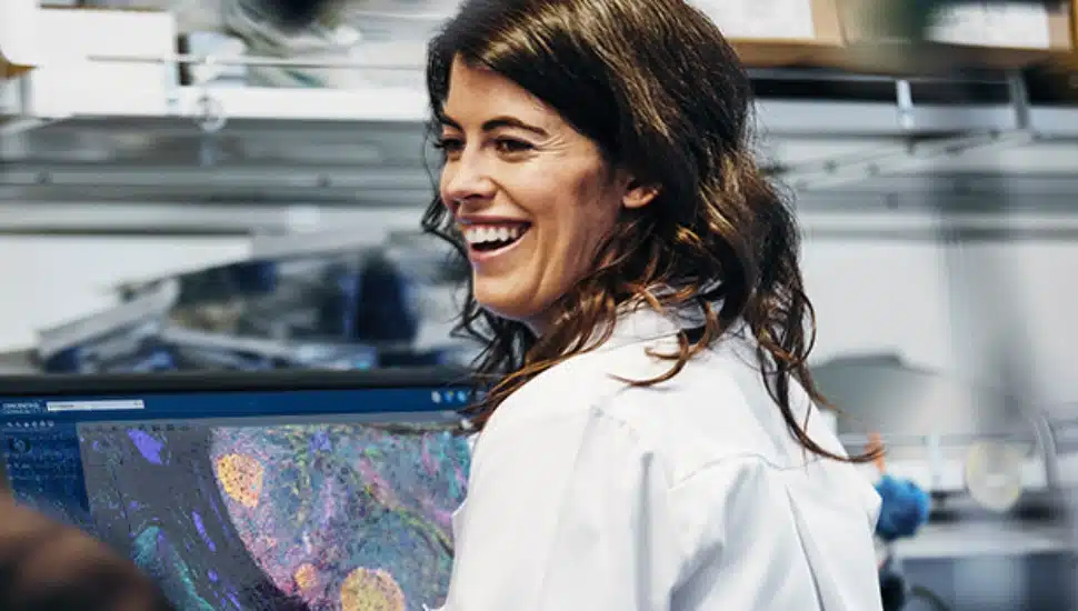 Woman smiling while in the lab.