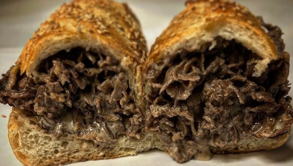 A cheesesteak from Angelo's Pizzeria cut into two.