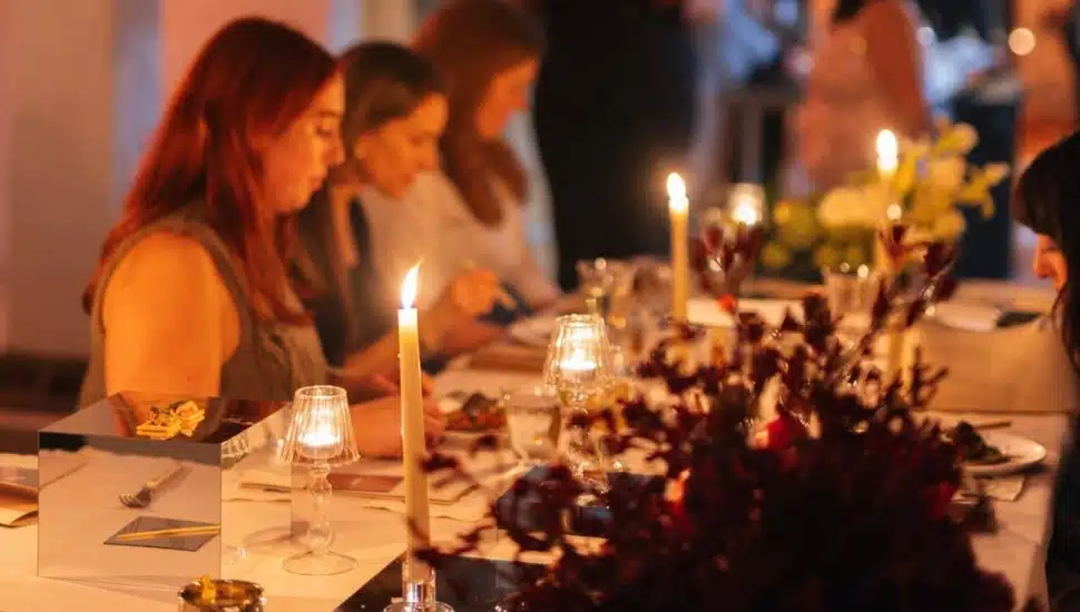 Women enjoying a candlelit meal.
