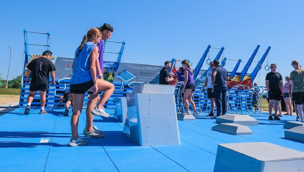 People exercising at outdoor fitness center.