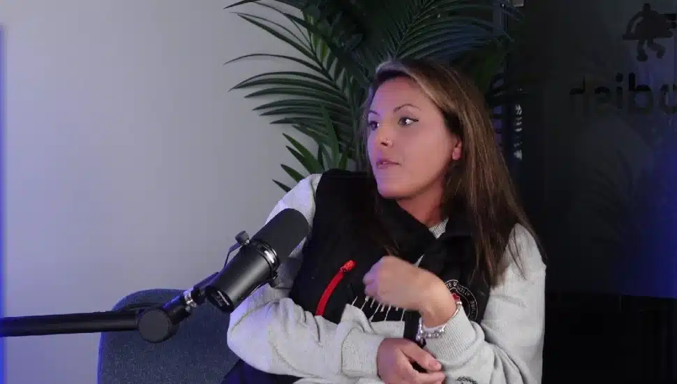Nicole Doyle speaking with a podcast mic in front of her.
