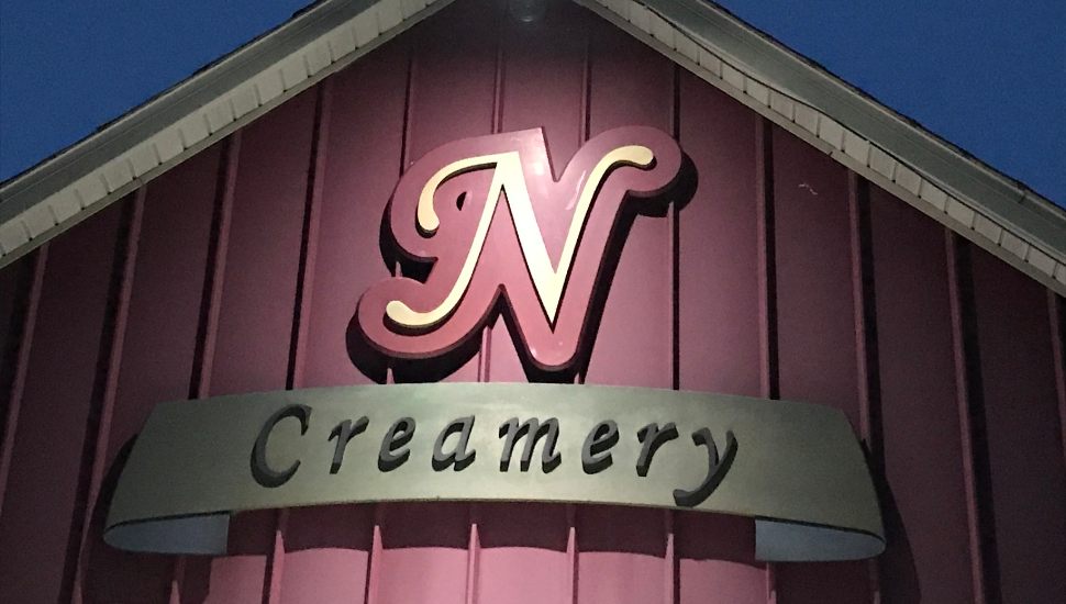 Nottingham Inn sign for creamery on side of barn.