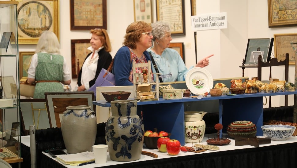 Two older women shop at an antique store.