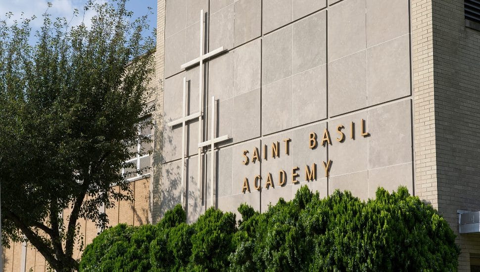 The stone facade and sign of St. Basil's Academy.