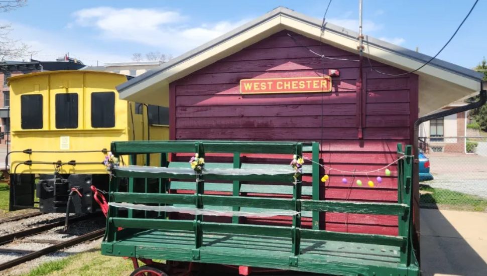 Yellow rail car and little red shed for West Chester railroad.