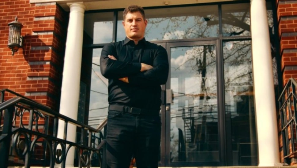 Former Philadelphia Eagles tight end Brent Celek stands at a building doorway.