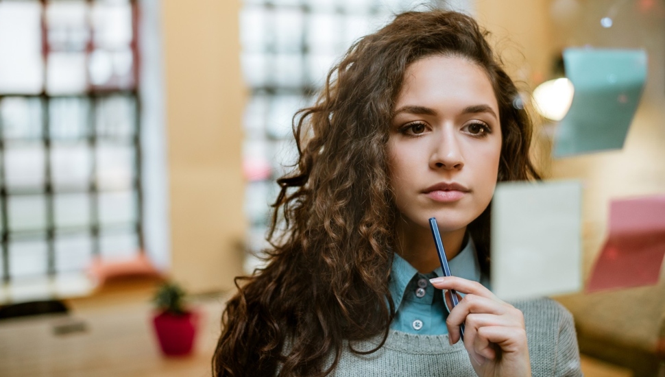 Concentrated woman making plan on sticky notes.