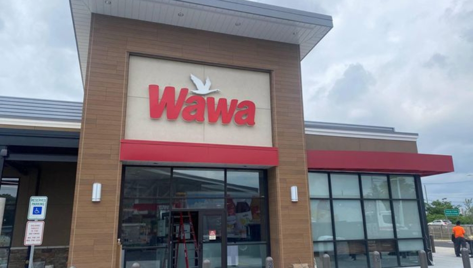 A exterior entrance and sign at a Wawa stadium store in South Philly.