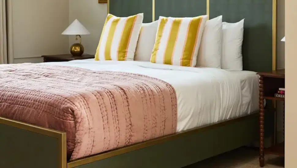 A bed inside “The Anna Suite by Anthropologie Home" at Hotel Anna & Bel.