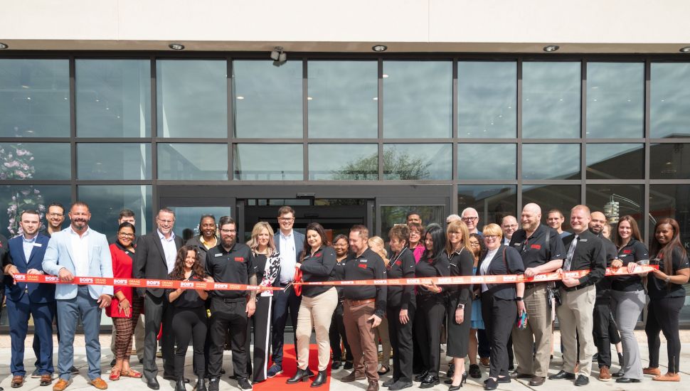 Staff gather to cut the ribbon at the Bob's Discount Furniture store in Montgomeryville.