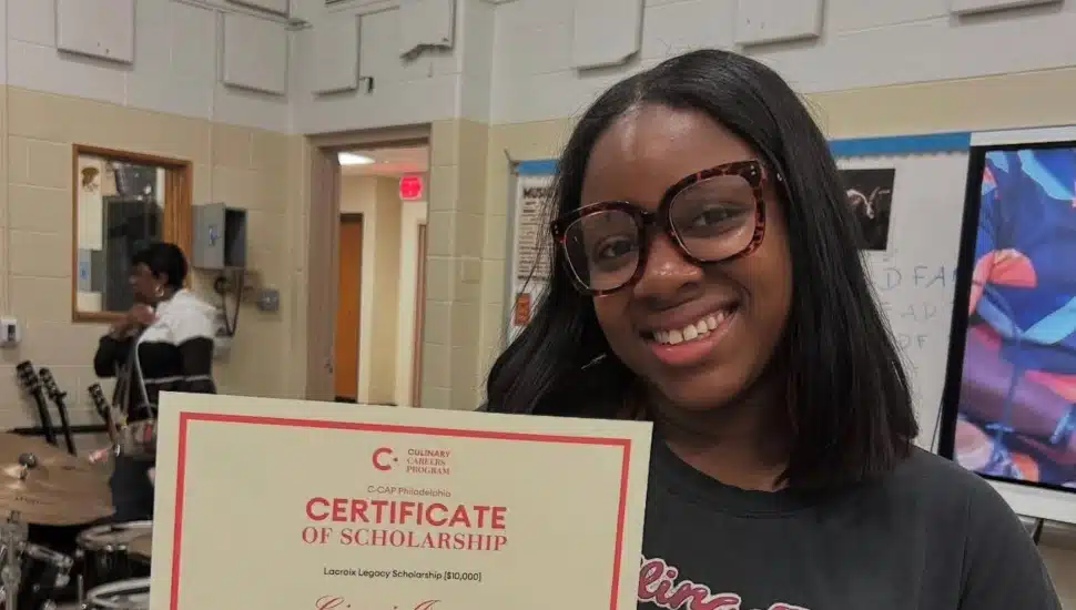 Ciani Jones holding her scholarship certificate.