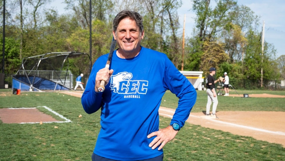 Jeff Manto holding a baseball bat and smiling.