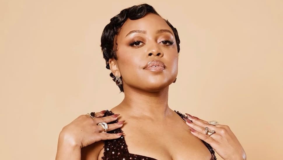 Quinta Brunson poses with hands on her shoulders.