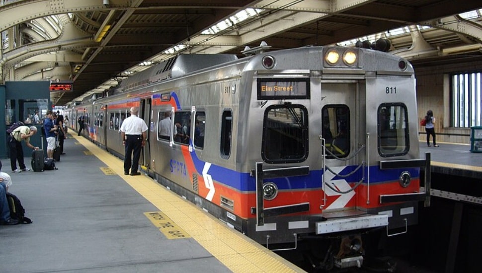 People on the platform waiting to enter into a Regional Rail.
