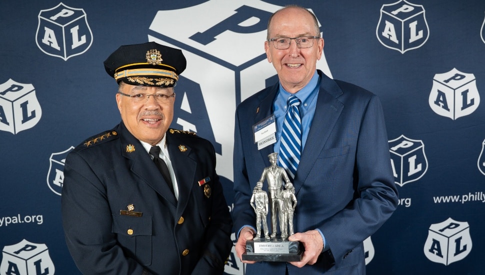 Police chief presents award to bank executive.