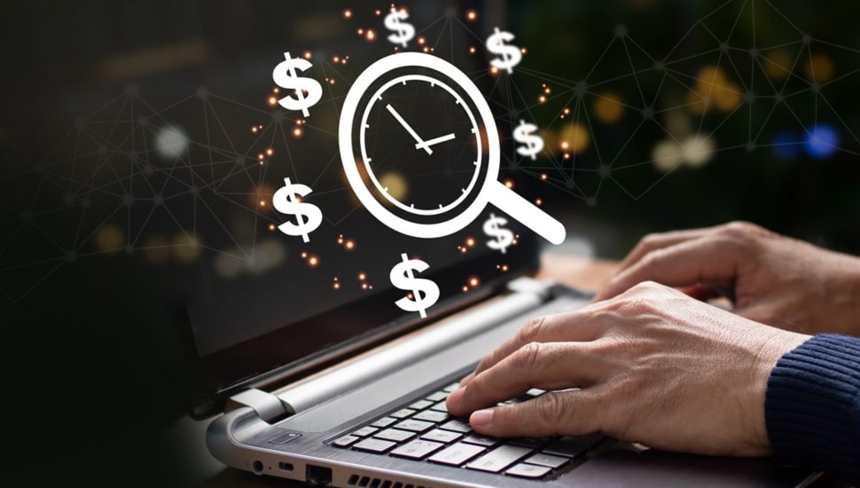 Man works at a laptop with a money-saving clock above.