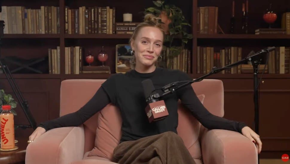 Alex Cooper sitting on a chair on her Call Her Daddy podcast.