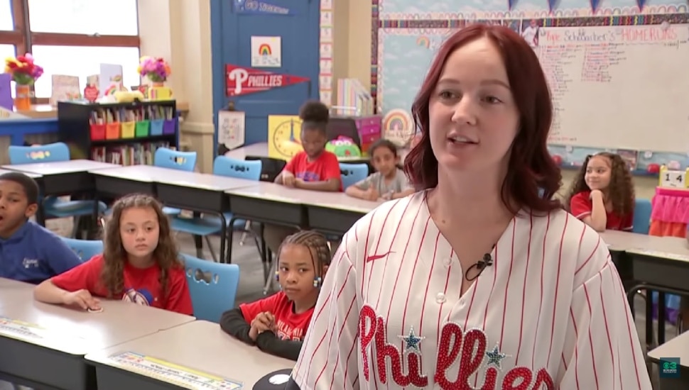 Amber Kiley inside her classroom with some of her students behind her.
