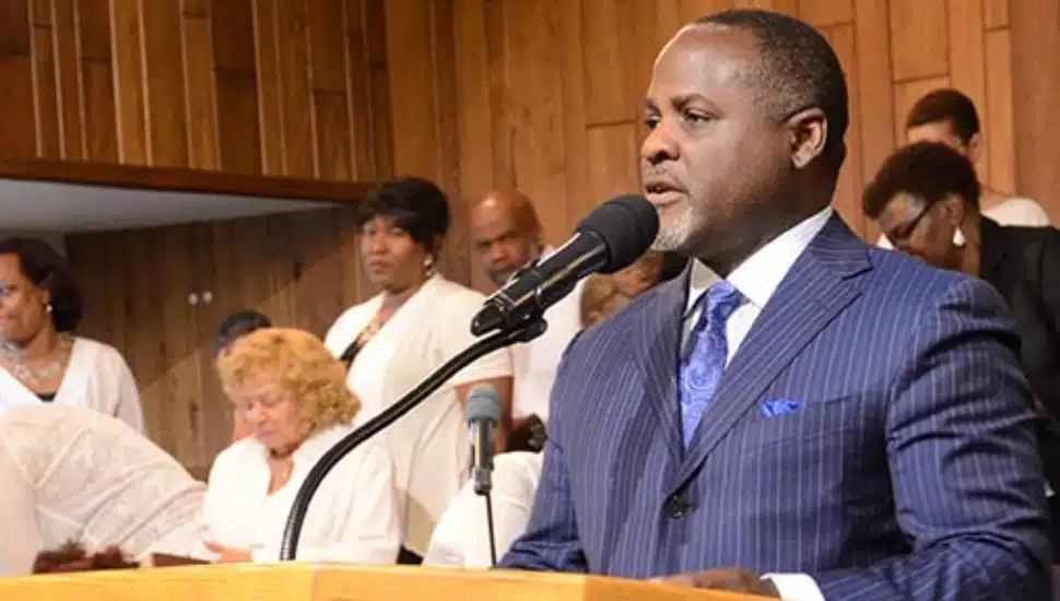 Dr. Darmone Jones preaching inside the church.