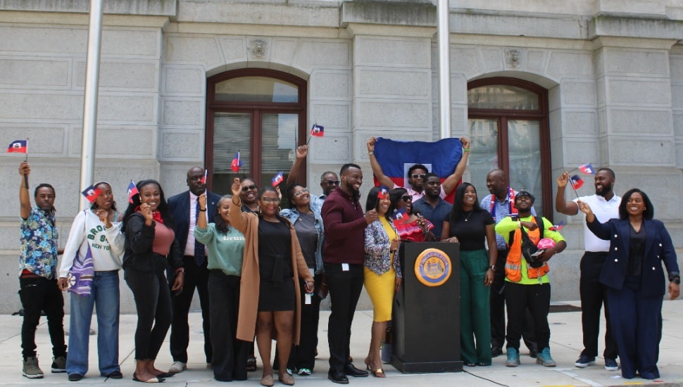 Philadelphia's Haitian and Haitian-American communities holding Haitian flags in the air.