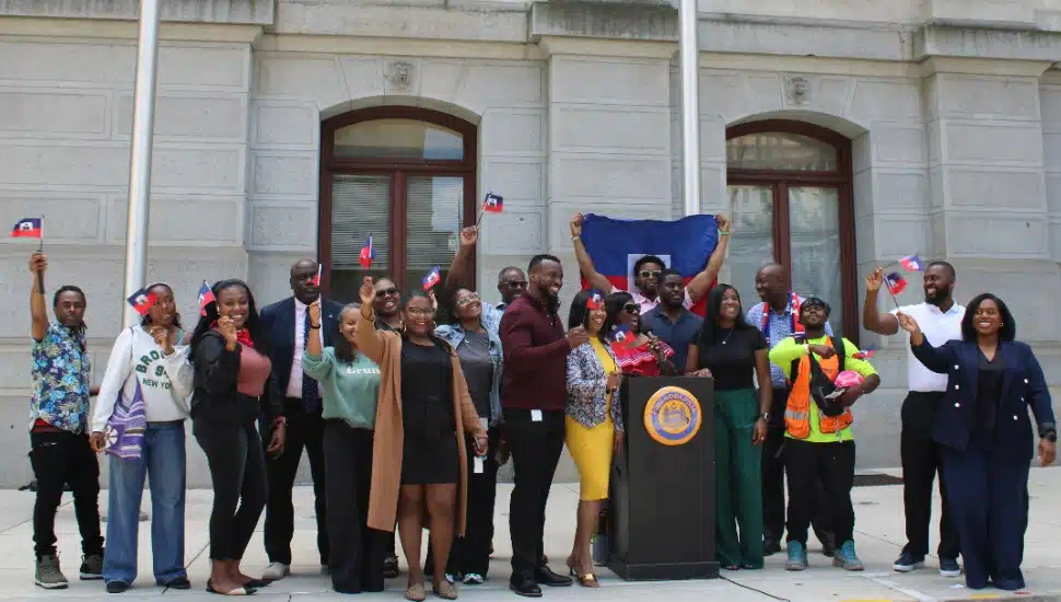 Philadelphia's Haitian and Haitian-American communities holding Haitian flags in the air.