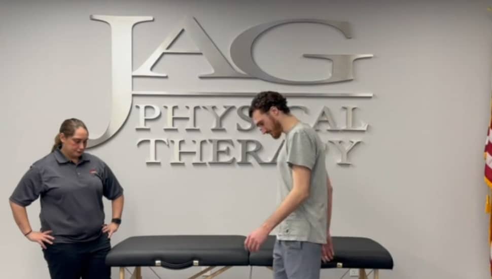 Two physical therapists in front of a therapy table at JAG Physical Therapy.