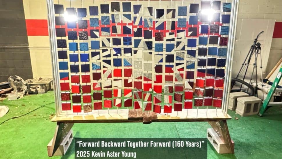 Kevin Aster Young art piece featuring 16 rows of 10 mini canvases arranged to create the Juneteenth flag.