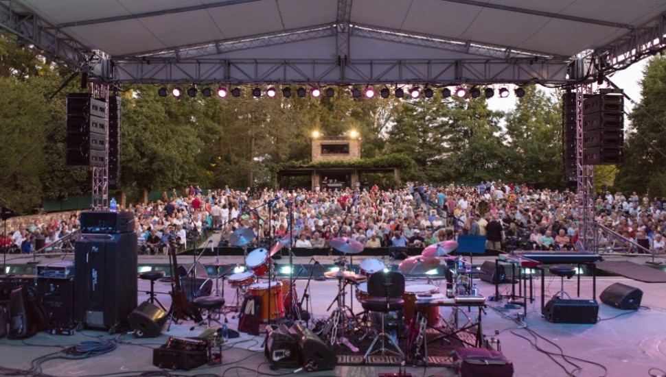 A stage and surrounding crowd at the outdoor Open Air theater at Longwood Gardens