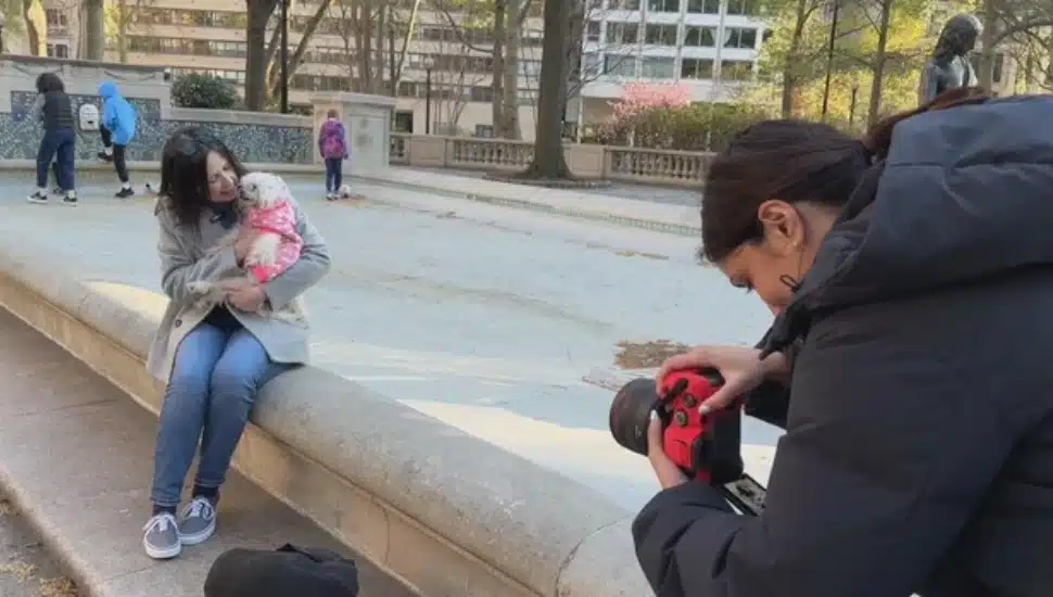 Nayana Gadde taking photo of woman with her dog