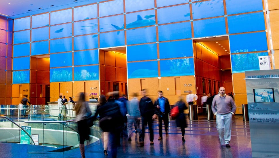 People walking inside Comcast building.