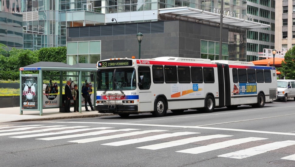 SEPTA bus at a bus stop with people getting ready to get on.