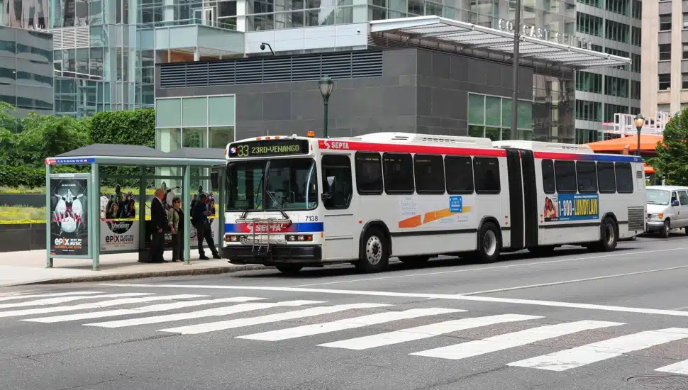 SEPTA bus at a bus stop with people getting ready to get on.