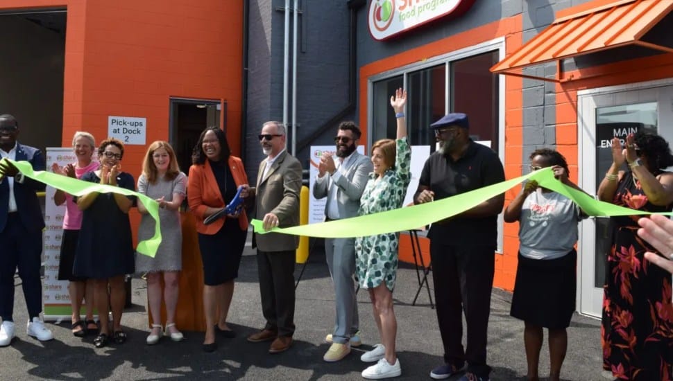 Dr. Monica Taylor, Delaware County Council chair, cuts the ribbon held by Marc Lucca, president of Aqua Pennsylvania, on Thursday at the new Share Food Program warehouse in Holmes.