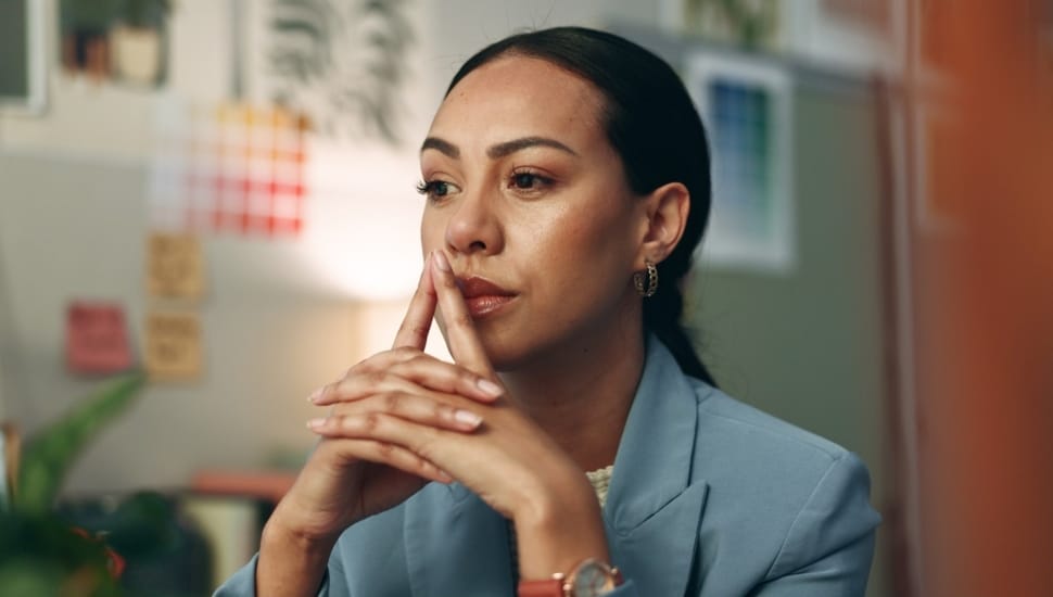 Businesswoman thinking at her desk.